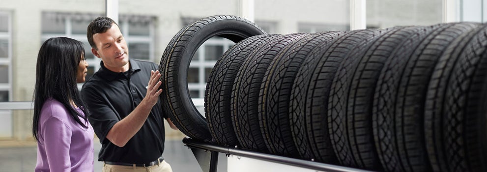 Subaru service representative showing customer a tire. | Tindol Subaru in Gastonia NC
