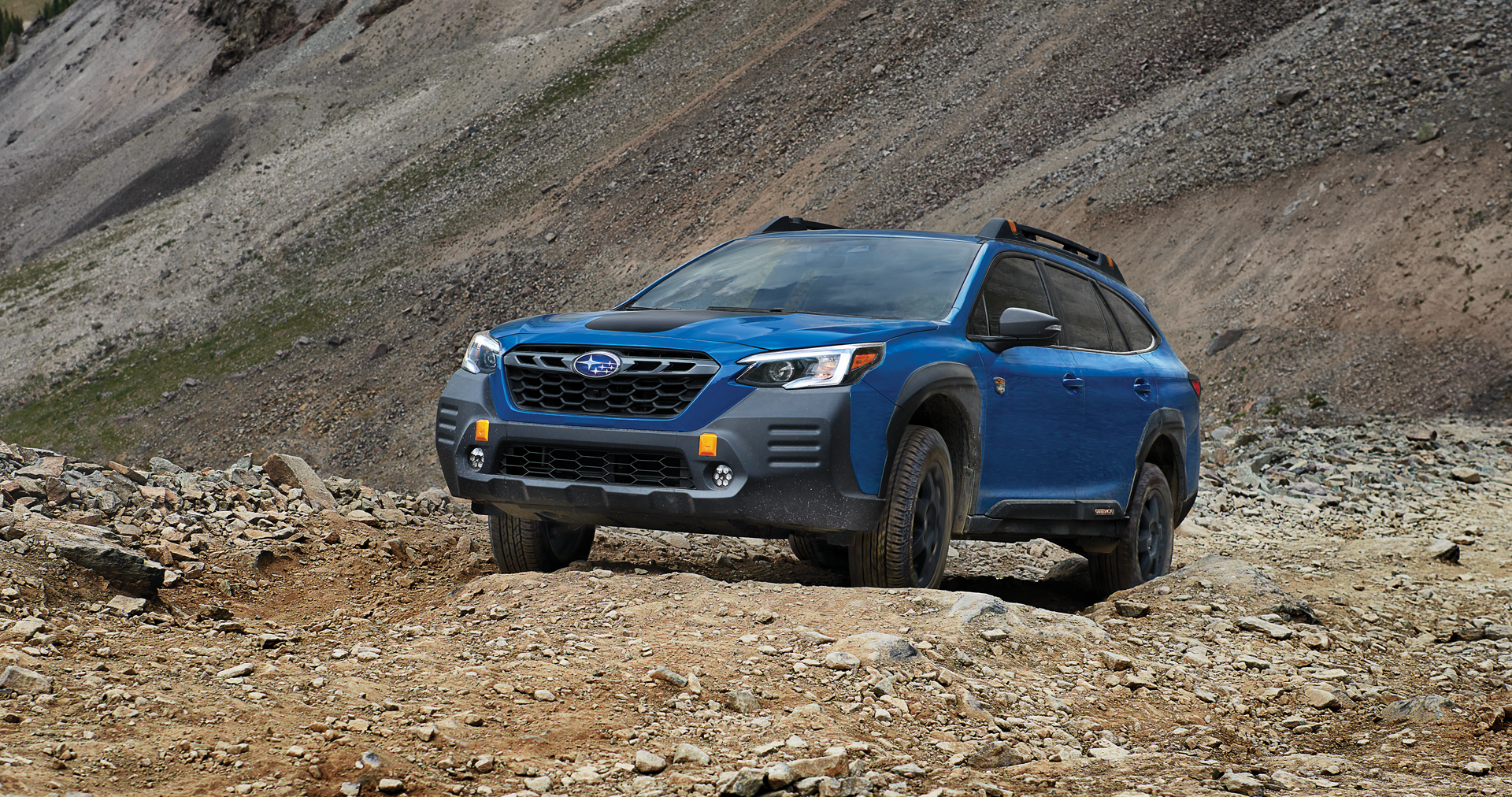 A 2023 Outback Wilderness driving on a trail in the mountains. | Tindol Subaru in Gastonia NC